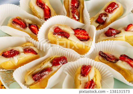 Assorted Caramel Pastries With Pecan Arranged In Paper Cups With Glossy Red Jam Centers, Toasted . Assorted Caramel Pastries With Pecan Arranged In Paper Cups With Glossy Red Jam Centers, Toasted . 138131573