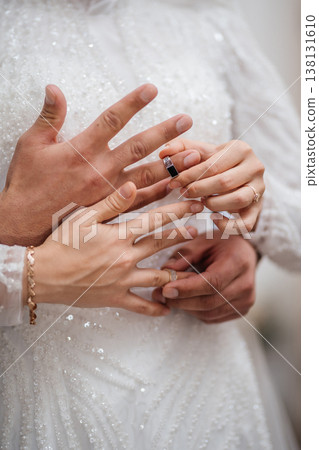 Closeup View Of Wedding Ring On Hand With Delicate Bracelet, Groom Hands Supporting, Sequin Gown . Closeup View Of Wedding Ring On Hand With Delicate Bracelet, Groom Hands Supporting, Sequin Gown . 138131610