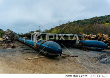 Inflatable Catamaran Boats Beached On Mudflat Under Overcast Sky, Roped Hulls Rest On Wet . Inflatable Catamaran Boats Beached On Mudflat Under Overcast Sky, Roped Hulls Rest On Wet . 138131622