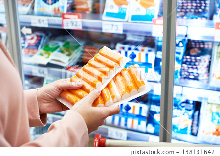 Crab sticks in hands buyer at store 138131642
