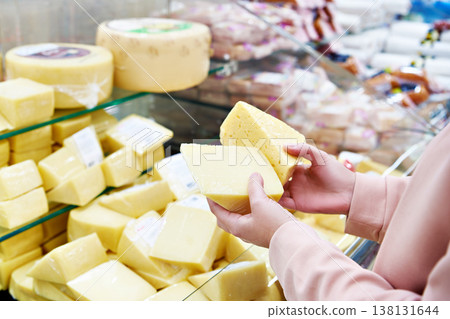 Hands with cheese in shop Hands with cheese in shop 138131644