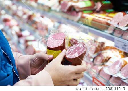 Sausage in hands buyer at shop 138131645