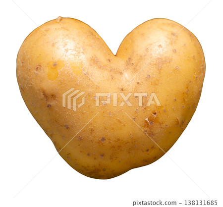 A heart-shaped potato sits isolated on a clear background. This potato shows a yellowish-brown color and has small eyes. It can be used for cooking or food decoration 138131685