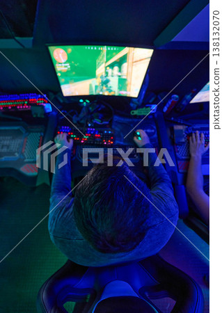 Competitive PC Gamer Playing FPS on RGB Monitor in Neon-Lit Esports Gaming Room 138132070