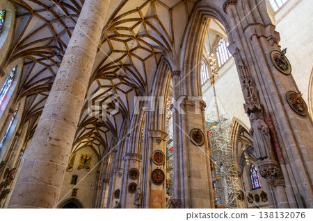 Interior view of Ulm Cathedral in Germany. Features ornate ceiling, detailed stone carvings, and stained glass windows. Gothic architecture highlights Interior view of Ulm Cathedral in Germany. Features ornate ceiling, detailed stone carvings, and stained glass windows. Gothic architecture highlights 138132076