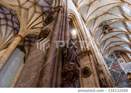 Interior view of Ulm Cathedral in Germany. Features ornate ceiling, detailed stone carvings, and stained glass windows. Gothic architecture highlights Interior view of Ulm Cathedral in Germany. Features ornate ceiling, detailed stone carvings, and stained glass windows. Gothic architecture highlights 138132080