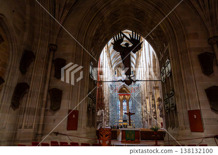 Interior view of Ulm Cathedral in Germany. Features ornate ceiling, detailed stone carvings, and stained glass windows. Gothic architecture highlights 138132100