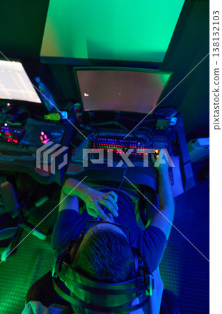 Young Gamer Playing PC Games With Headset and RGB Keyboard in Neon Gaming Room Young Gamer Playing PC Games With Headset and RGB Keyboard in Neon Gaming Room 138132103
