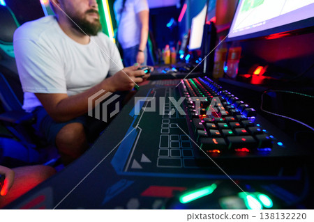 Friends Gaming Together at RGB PC Setup With Mechanical Keyboard and Game Controller in LAN Cafe 138132220