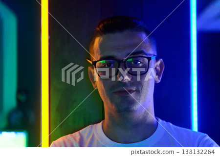 Young Man Wearing Glasses in Neon Portrait With Blue and Yellow LED Lighting, Urban Mood Young Man Wearing Glasses in Neon Portrait With Blue and Yellow LED Lighting, Urban Mood 138132264