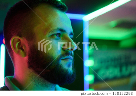 Neon Portrait Of Bearded Man In Profile With Colorful Lights And Thoughtful Expression 138132298