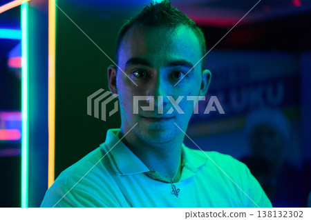 Neon Portrait Of A Young Man In Nightclub Lighting With Moody Blue Green Colors And Confidence 138132302