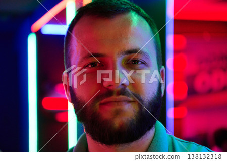 Young Bearded Man Portrait in Neon Lights Showing Confidence and Nightlife Vibes Young Bearded Man Portrait in Neon Lights Showing Confidence and Nightlife Vibes 138132318