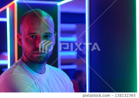 Neon Portrait Of A Thoughtful Man In Colorful LED Lighted Interior Neon Portrait Of A Thoughtful Man In Colorful LED Lighted Interior 138132365