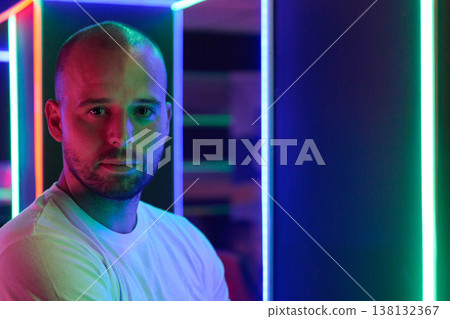 Neon Portrait Of Confident Man In Colorful LED Lights Studio With Cinematic Mood Neon Portrait Of Confident Man In Colorful LED Lights Studio With Cinematic Mood 138132367