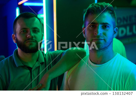 Two Male Friends Neon Portrait in Nightclub Lighting With Casual Fashion and City Vibe Two Male Friends Neon Portrait in Nightclub Lighting With Casual Fashion and City Vibe 138132407