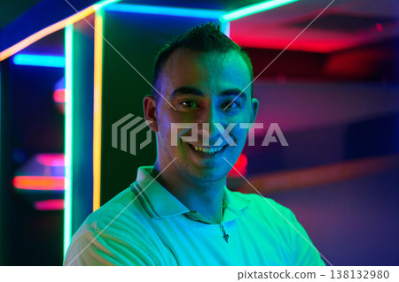 Smiling Man Portrait in Neon Lights Nightlife Colorful Urban Mood and Modern Club Atmosphere Smiling Man Portrait in Neon Lights Nightlife Colorful Urban Mood and Modern Club Atmosphere 138132980