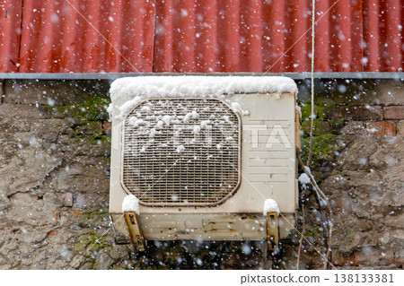 Air conditioner on roof during snow 138133381