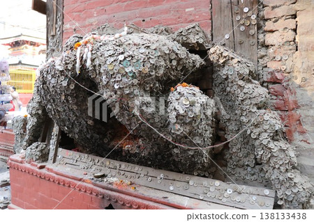 A coin tree in Kathmandu, Nepal, with coins nailed to it that is said to enshrine a god who cures toothaches A coin tree in Kathmandu, Nepal, with coins nailed to it that is said to enshrine a god who cures toothaches 138133438