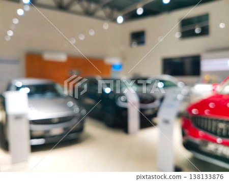 Blurred car showroom interior with luxury vehicles on display Blurred car showroom interior with luxury vehicles on display 138133876