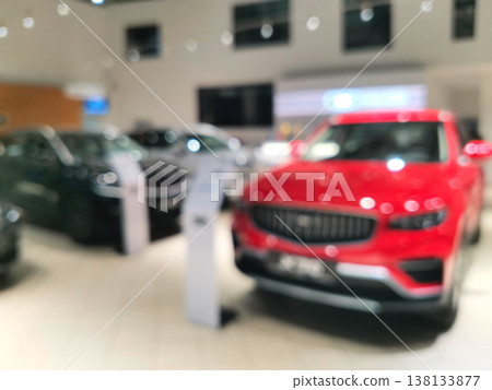 Blurred view of a modern car dealership showroom with vehicles Blurred view of a modern car dealership showroom with vehicles 138133877