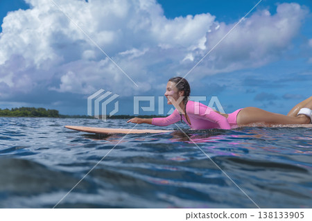 Woman Practicing Accurate Surfing Skills In Peaceful Seaside Environment Woman Practicing Accurate Surfing Skills In Peaceful Seaside Environment 138133905