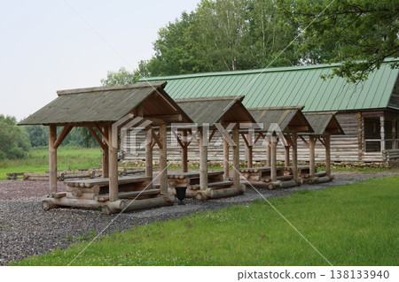 Open timber structures featuring green roofs and gravel paths 138133940