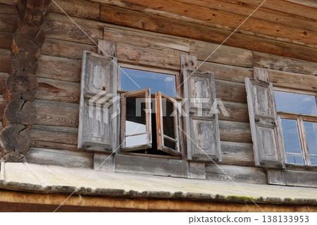 Vintage wooden window showcasing weathered shutters and reflections Vintage wooden window showcasing weathered shutters and reflections 138133953