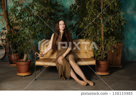 Modern female model appearing in sophisticated interior setting Modern female model appearing in sophisticated interior setting 138133985