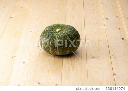 Green pumpkin on a wooden table Green pumpkin on a wooden table 138134074