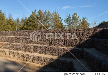 Gabions Stabilize Slopes. Modern Gabion Walls Enhance Landscape Stability Naturally And Sustainably Gabions Stabilize Slopes. Modern Gabion Walls Enhance Landscape Stability Naturally And Sustainably 138134107