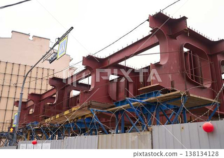 Civil engineers organize installation of bridge girders amidst skyline Civil engineers organize installation of bridge girders amidst skyline 138134128
