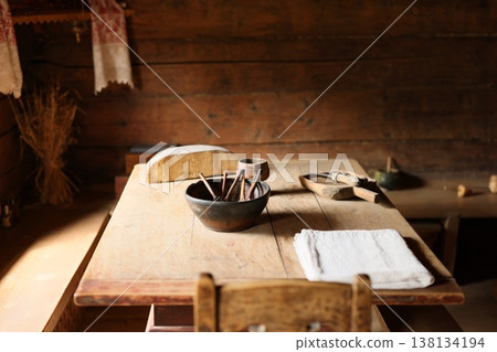 Oldfashioned schoolroom with writing tools and embroidered cloth 138134194