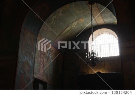Historic shrine featuring illuminated frescoes and grand chandelier 138134204