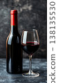 A Beautifully Arranged Table Setting for a Fine Dinner Featuring a Vintage Wine and Grapes 138135530