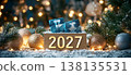 Festive 2027 New Year Celebration with Shimmering Golden Numbers and Snowy Holiday Ornaments 138135531