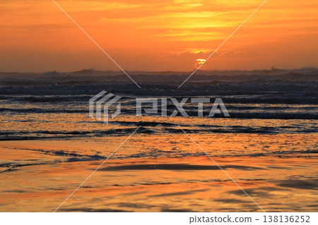 Clouds visible beyond the sunrise sky and the sea. 138136252