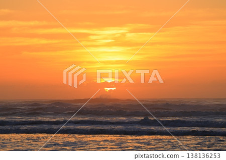 Clouds visible beyond the sunrise sky and the sea. Clouds visible beyond the sunrise sky and the sea. 138136253