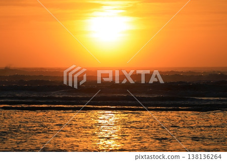 Clouds visible beyond the sunrise sky and the sea. 138136264