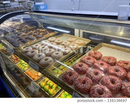 Colorful American donuts lined up in the display case of a Boston donut shop. 138136697
