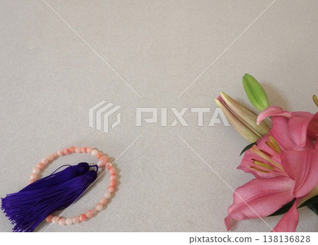 Prayer beads and pink lilies: an image of a Buddhist memorial service. 138136828