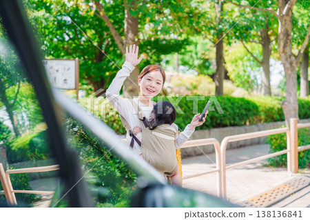 Mom calls a taxi with her baby Mom calls a taxi with her baby 138136841