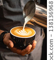 A skilled barista showcases their artistry, pouring creamy milk into a perfectly brew 138136968