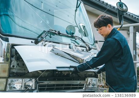 Driver opening the truck's front panel Driver opening the truck's front panel 138136989