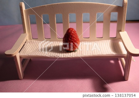 Strawberries on a table with a white chair Strawberries on a table with a white chair 138137054