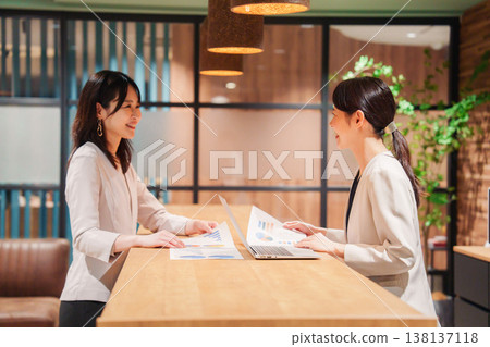 Two women having a meeting in an office 138137118