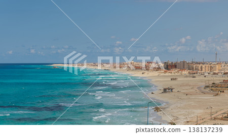The cityscape of Marsa Matruh, Egypt, and the turquoise blue coastline of the Mediterranean Sea. The cityscape of Marsa Matruh, Egypt, and the turquoise blue coastline of the Mediterranean Sea. 138137239