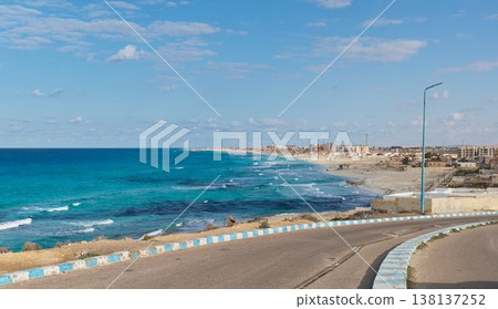 The coastal road in Marsa Matruh, overlooking the turquoise Mediterranean Sea and its coastline. The coastal road in Marsa Matruh, overlooking the turquoise Mediterranean Sea and its coastline. 138137252