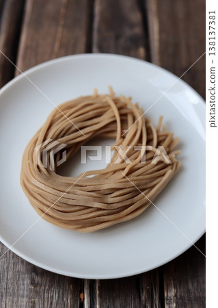 Healthy brown rice noodles before boiling; gluten-free noodles 138137381