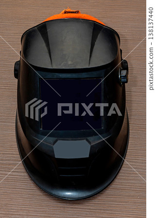 Protective welder helmet on table 138137440